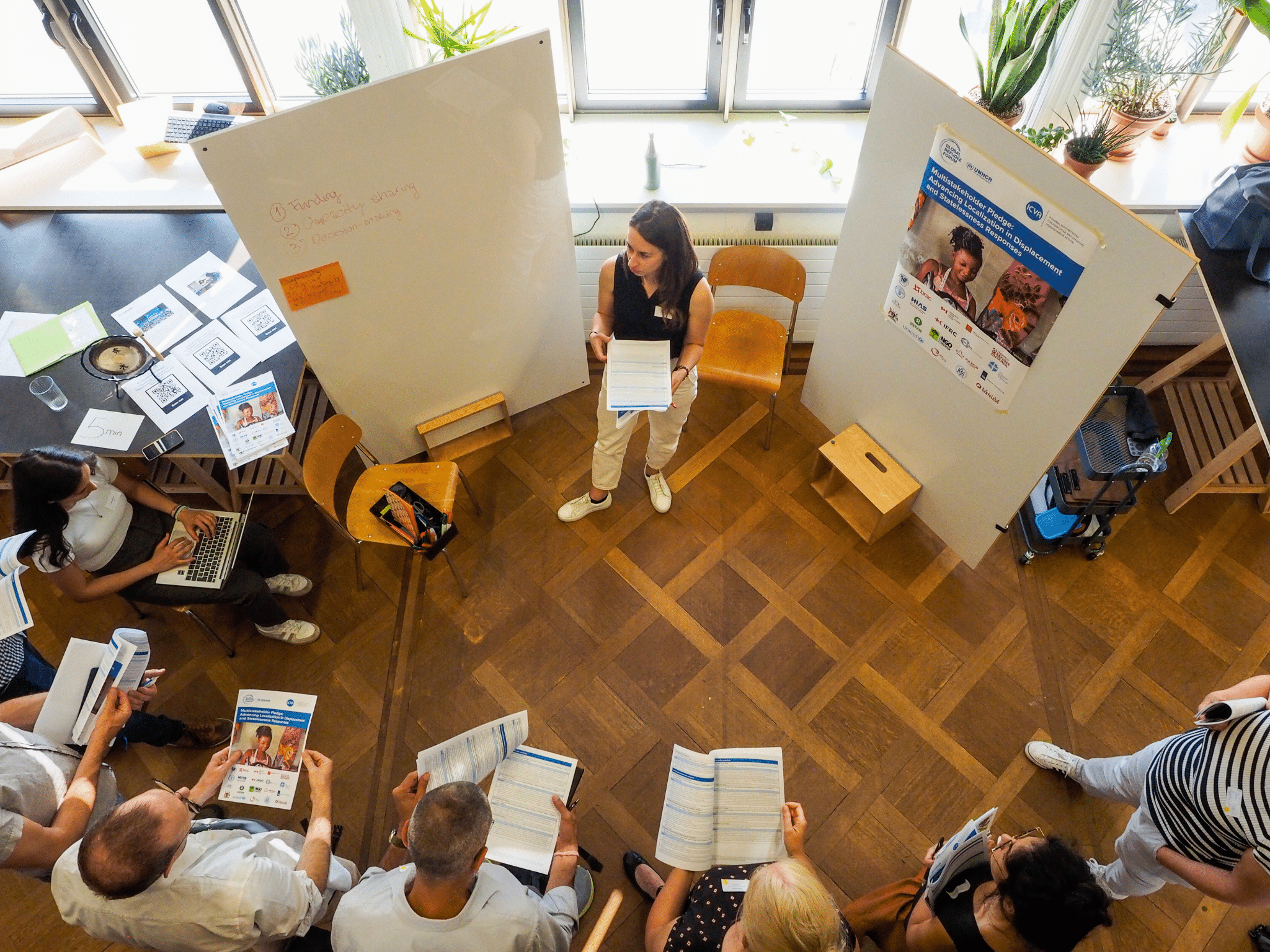 People in a workshop session standing in a circle.