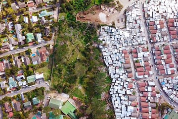 Drone footage of poor neighbourhood next to rich area