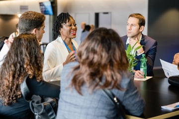 People having a meeting around a table.