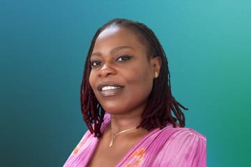 Portrait of Ndeye Fatouh Faye Smiling person with dreadlocks on blue-green background.