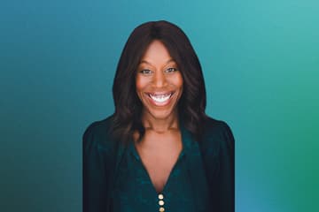 Smiling woman against gradient background.