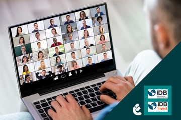 A person sits in front of a computer during an online meeting or webinar.